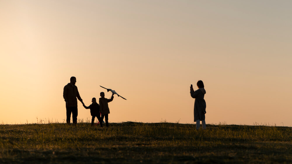 Silhouette of a family enjoying time together at sunset, symbolizing love, connection, and shared values—key considerations when choosing guardians for children, as discussed by TLR Law in Winnipeg.