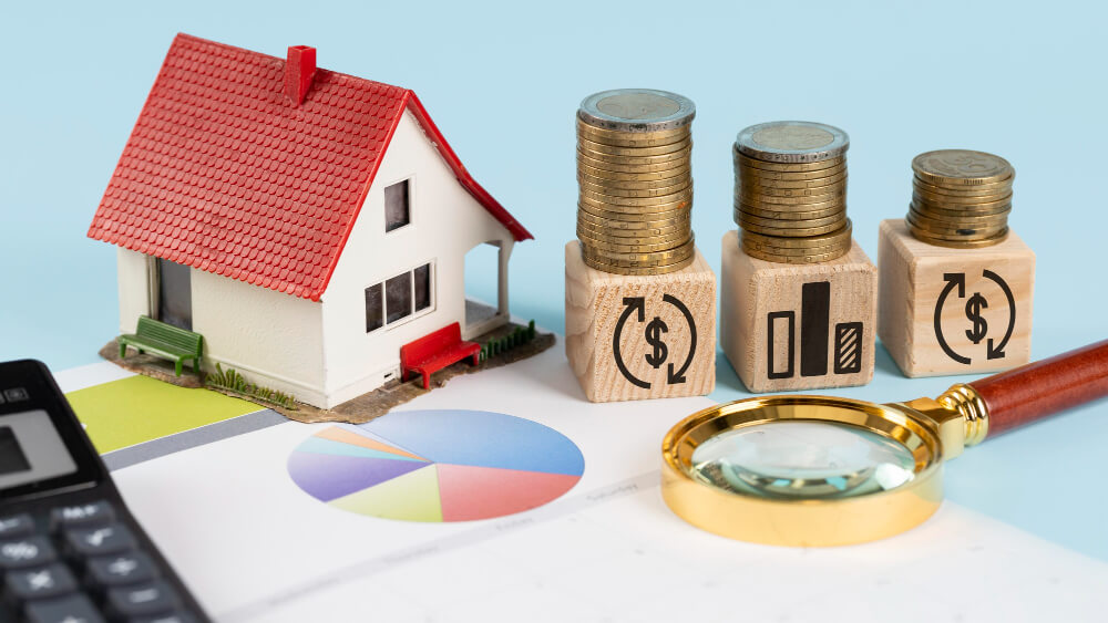Model house beside stacked coins, financial charts, and a magnifying glass symbolizing asset division and property rights for common-law couples, with legal guidance from TLR Law in Manitoba.