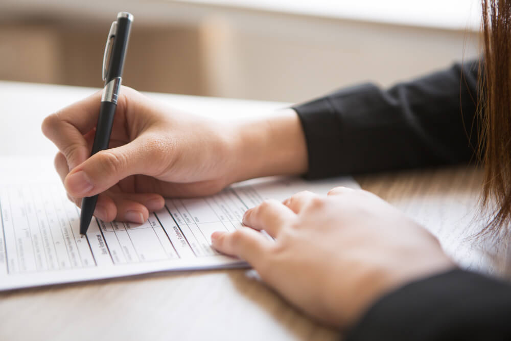 Reviewing beneficiary designation forms for an estate plan with TLR Law in Winnipeg, Manitoba.