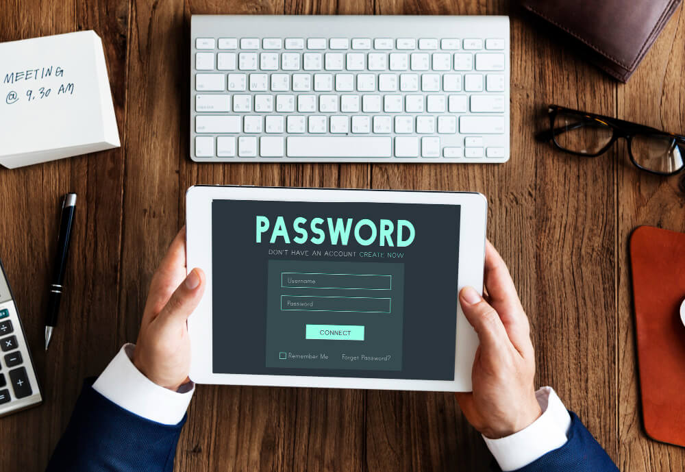 Person holding a tablet displaying a password login screen, representing digital estate planning and secure account access for executors with TLR Law in Manitoba.