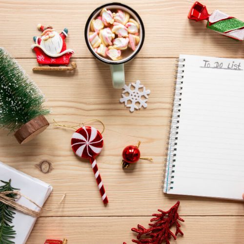 Year-end planning checklist with holiday decorations and notepad, representing wills, powers of attorney, and December legal planning in Manitoba with TLR Law.
