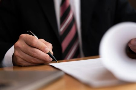 Professional reviewing estate documents and paperwork, representing probate applications, executor responsibilities, and estate administration guidance from TLR Law in Manitoba.