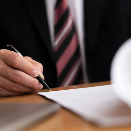 Professional reviewing estate documents and paperwork, representing probate applications, executor responsibilities, and estate administration guidance from TLR Law in Manitoba.