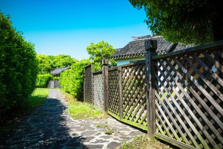 Residential fence running alongside a property, illustrating property boundaries, title insurance, and survey considerations with legal guidance from TLR Law in Manitoba.