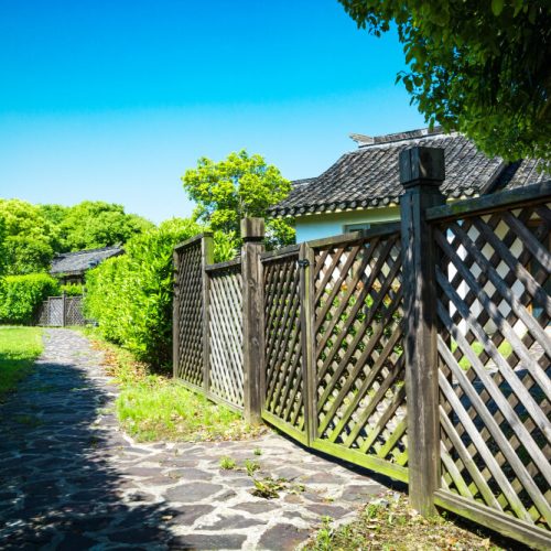 Residential fence running alongside a property, illustrating property boundaries, title insurance, and survey considerations with legal guidance from TLR Law in Manitoba.