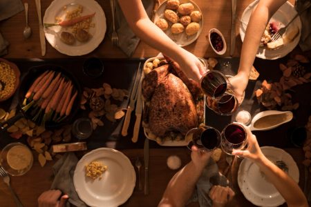Family sharing Thanksgiving dinner together, representing conversations about wills, executors, and estate planning with TLR Law in Winnipeg, Manitoba.