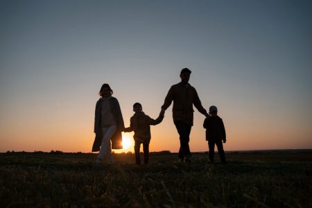 Parents walking with their children at sunset, representing the changing legal role of parents when a child turns 18 and young adult planning with TLR Law in Manitoba.