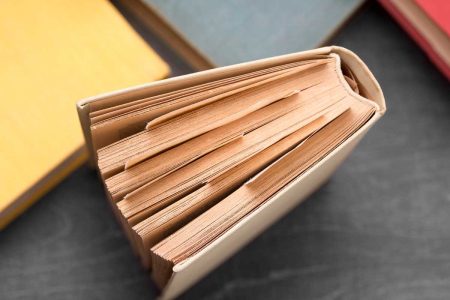 Close-up of a worn corporate minute book, highlighting the importance of business record-keeping for Manitoba owners.