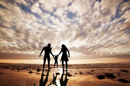 Silhouetted family holding hands on a beach at sunset, representing legacy, unity, and the lasting impact of family values. This image reflects TLR Law’s commitment to helping families in Winnipeg protect their future through thoughtful estate planning.